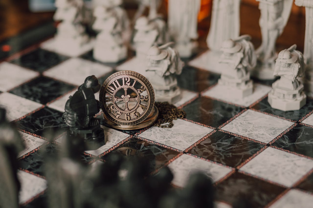 Close-up of a detailed chess set inspired by fantasy themes with a magical vintage clock on the board.
